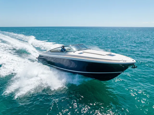 Sleek speedboat skimming across turquoise water with spray